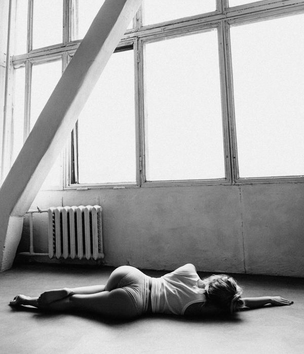 Woman in a calm yoga pose in a modern studio.